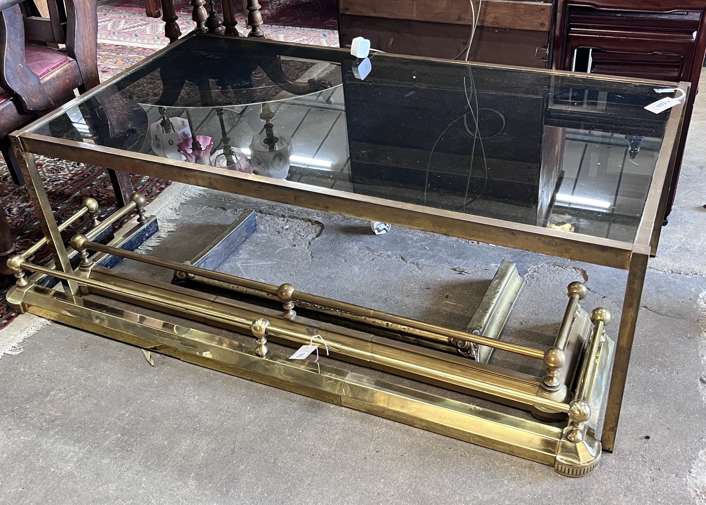 A mid century rectangular brass and smoked glass coffee table, length 135cm, depth 70cm, height 47cm